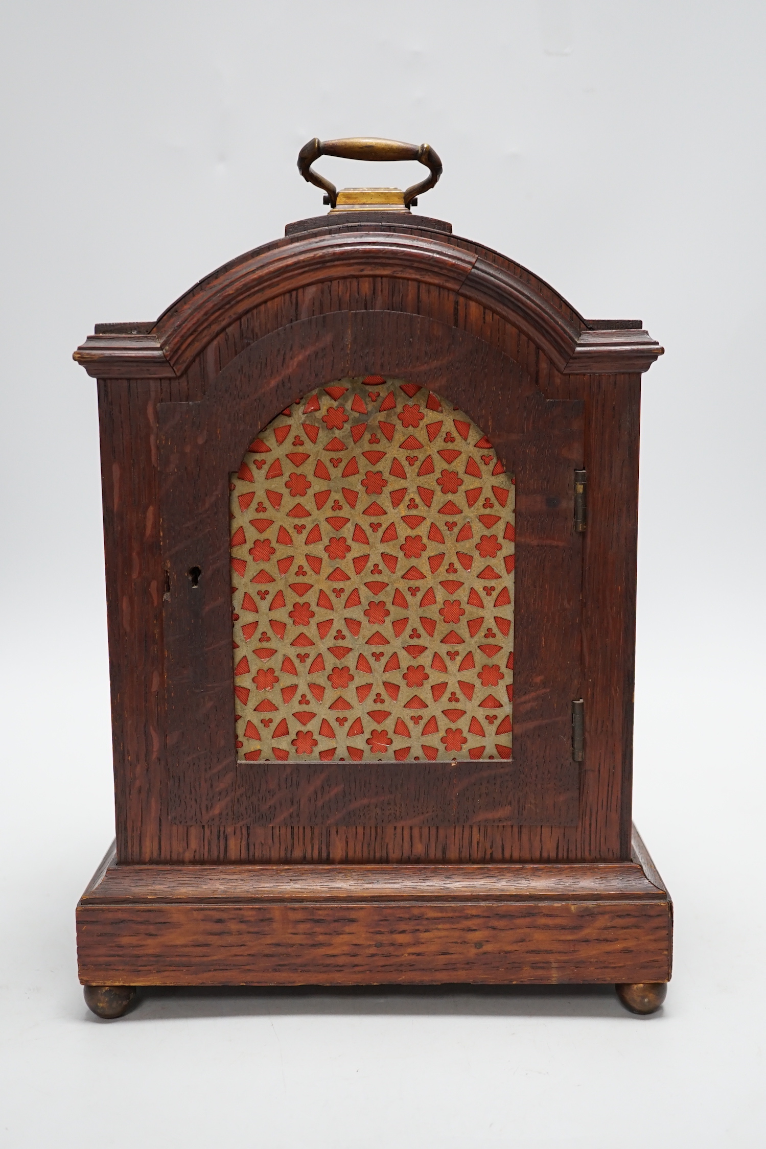 A oak mantel clock in a Regency style with pad top, striking on a coiled gong, 30cm high